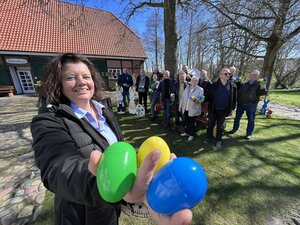Bürgermeisterin hält bunte Ostereier in den Händen